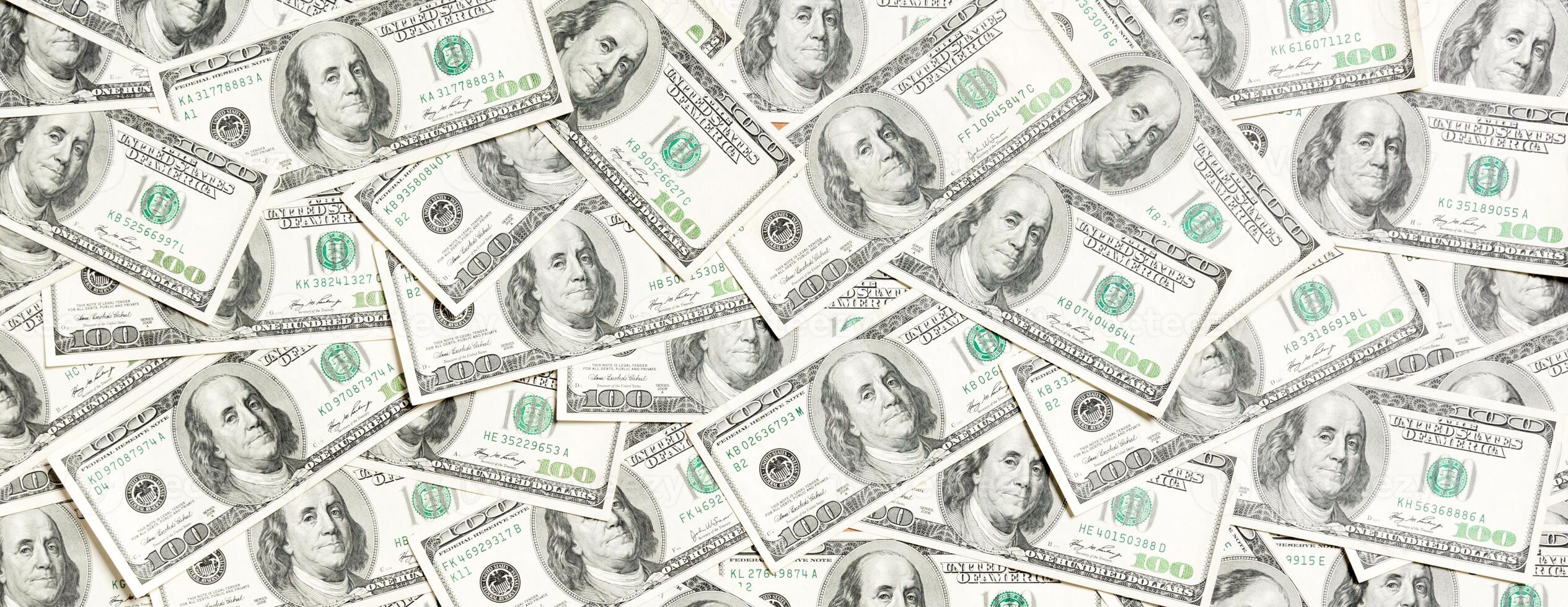 Top view of one hundred dollar banknotes made as a background. USD currency concept. Texture of American dollars photo