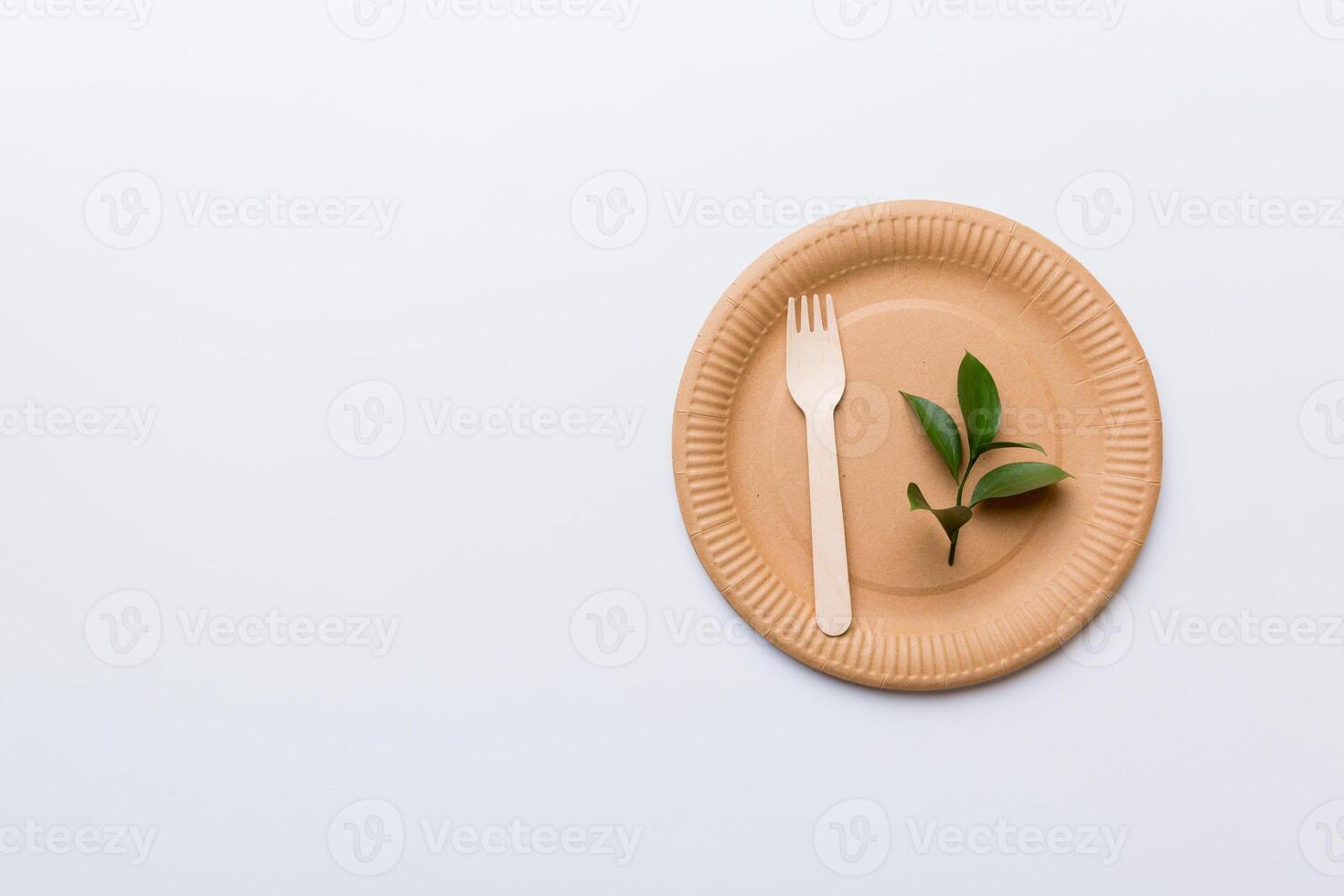 set of empty reusable disposable eco-friendly plates, cups, utensils on light white colored table background. top view. Biodegradable craft dishes. Recycling concept. Close-up photo