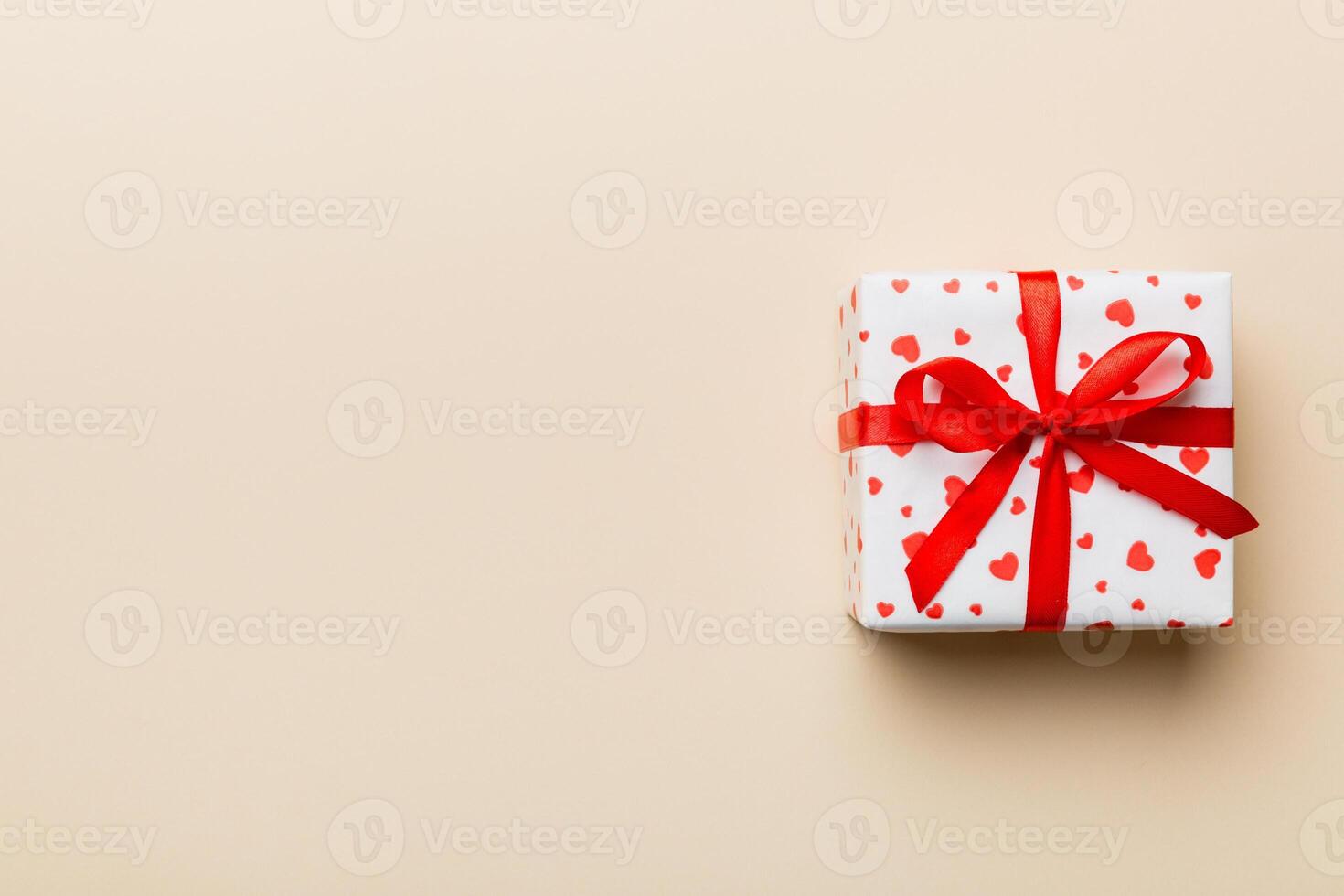 Valentine day composition Background red gift box with bow and heart. Christmas present. View from above. Holday greeting card photo