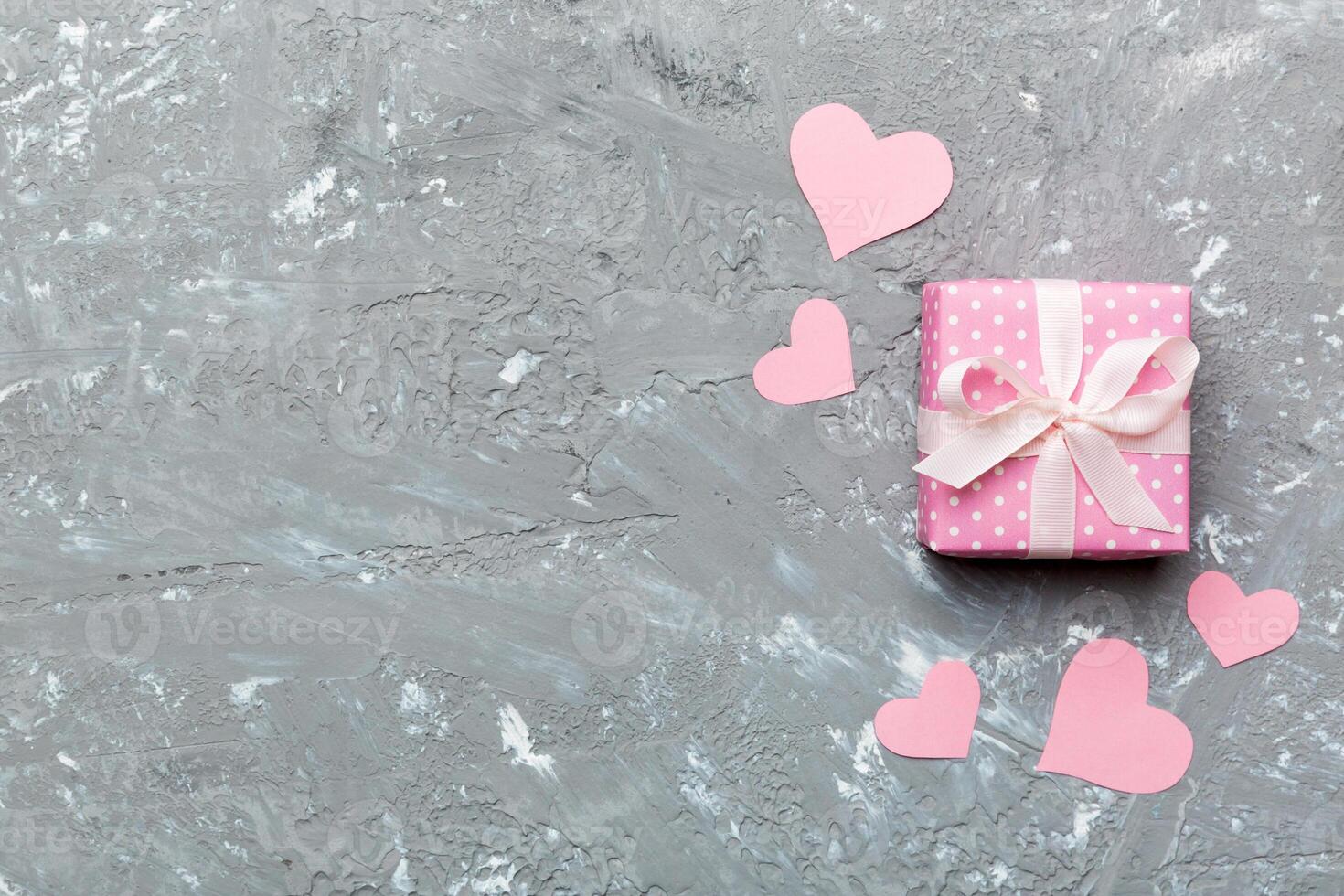 Valentine day composition Background red gift box with bow and heart. Christmas present. View from above. Holday greeting card photo