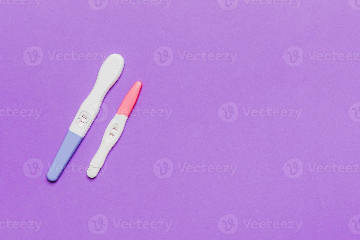 Colored Pregnancy test on colored background, top view with copy space photo