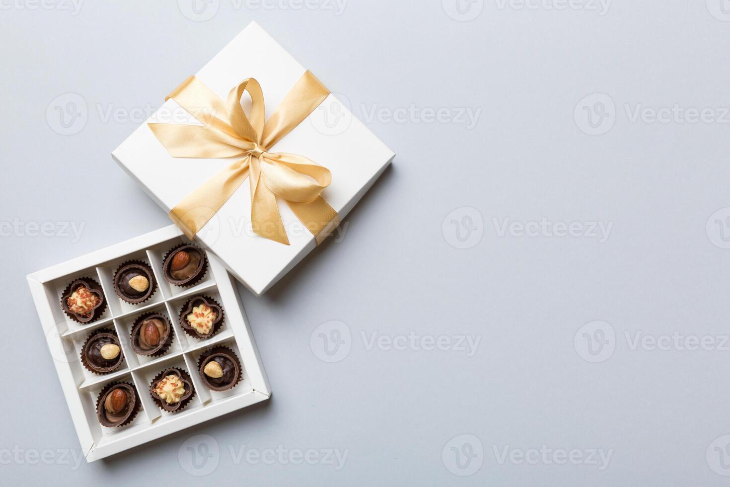 White box with chocolates candies and golden tape. top view with copy space photo