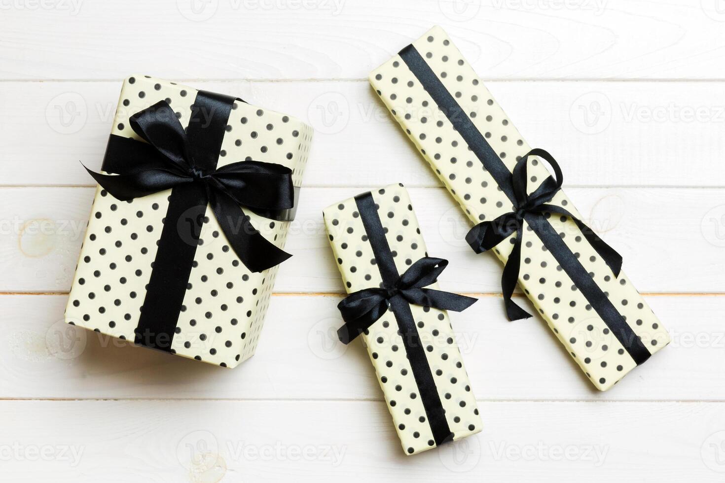 Top view of christmas or other holiday handmade present box package, flat lay white wooden background with copy space. new year gift box photo