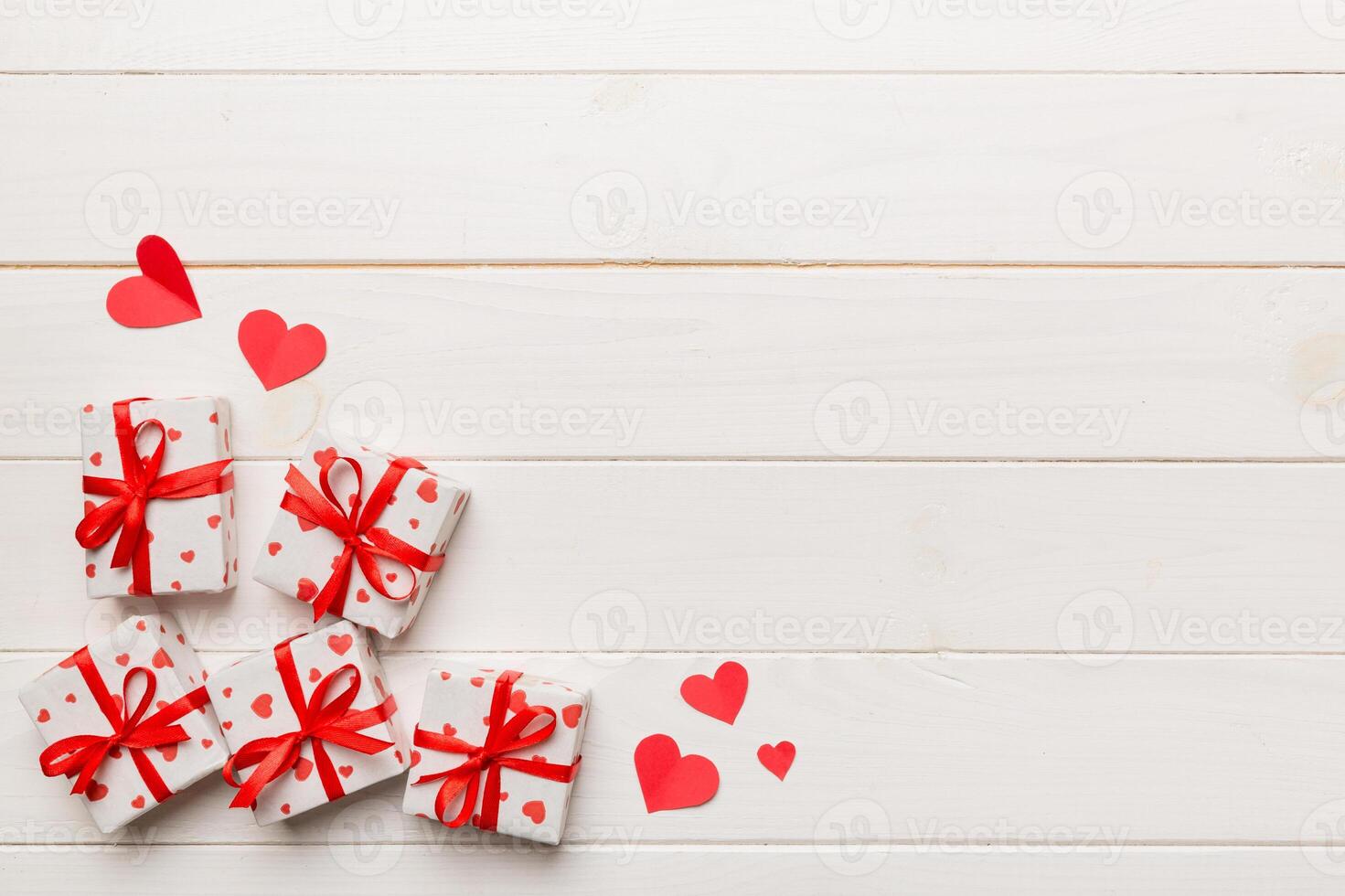 Valentine day composition Background red gift box with bow and heart. Christmas present. View from above. Holday greeting card photo