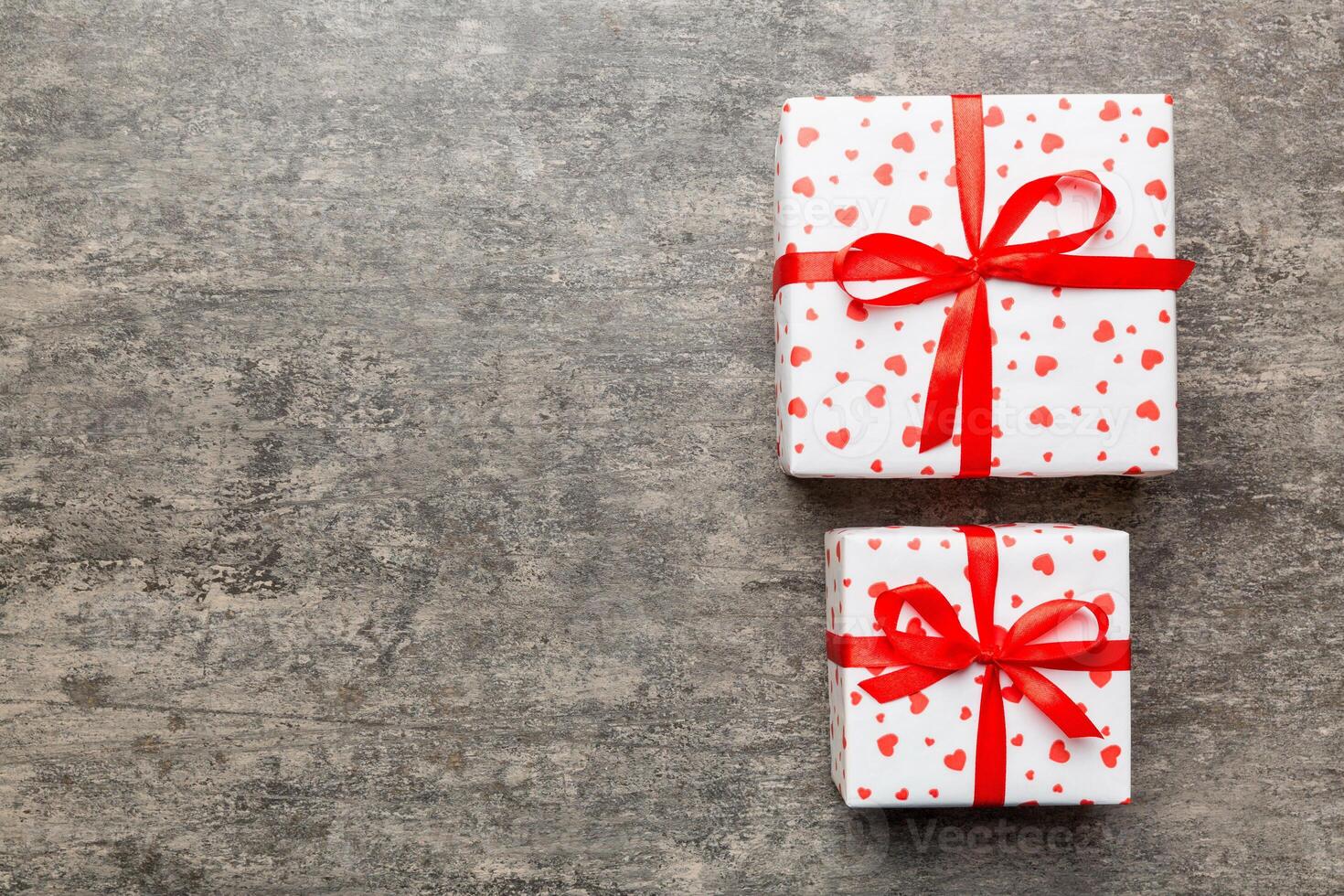 Valentine day composition Background red gift box with bow and heart. Christmas present. View from above. Holday greeting card photo