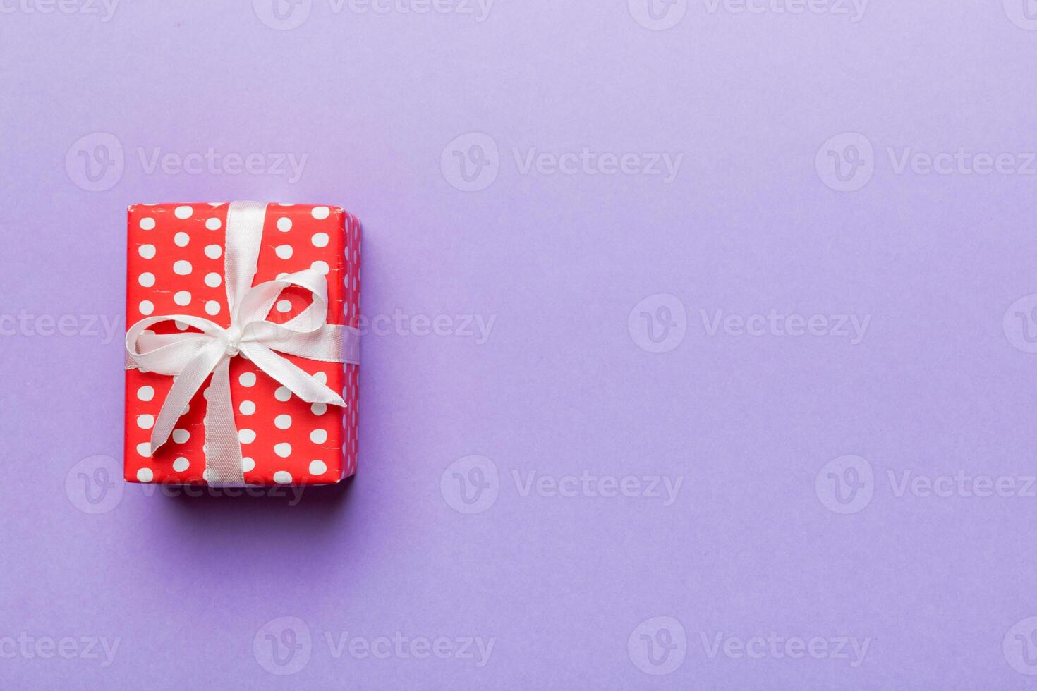 Valentine day composition Background red gift box with bow and heart. Christmas present. View from above. Holday greeting card photo