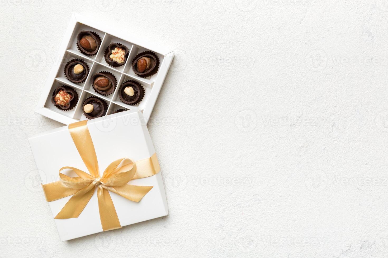 White box with chocolates candies and golden tape. top view with copy space photo