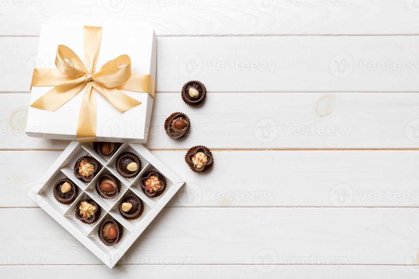 White box with chocolates candies and golden tape. top view with copy space photo