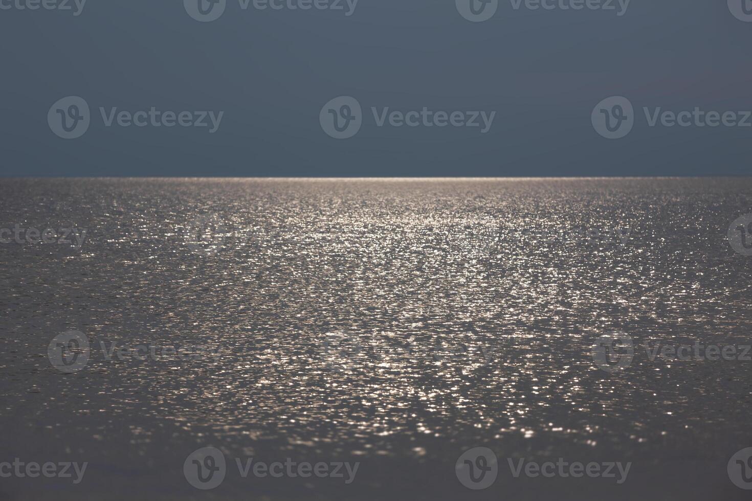 Sun glare on the sea surface in calm, breezy weather. photo