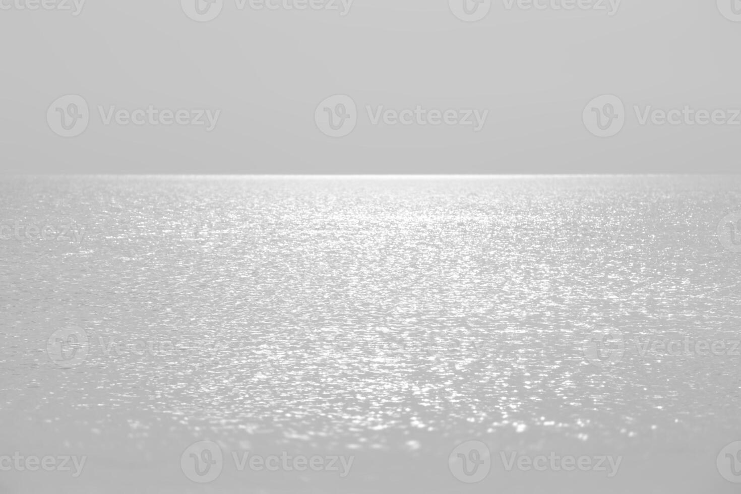 Sun glare on the sea surface in calm, breezy weather. photo