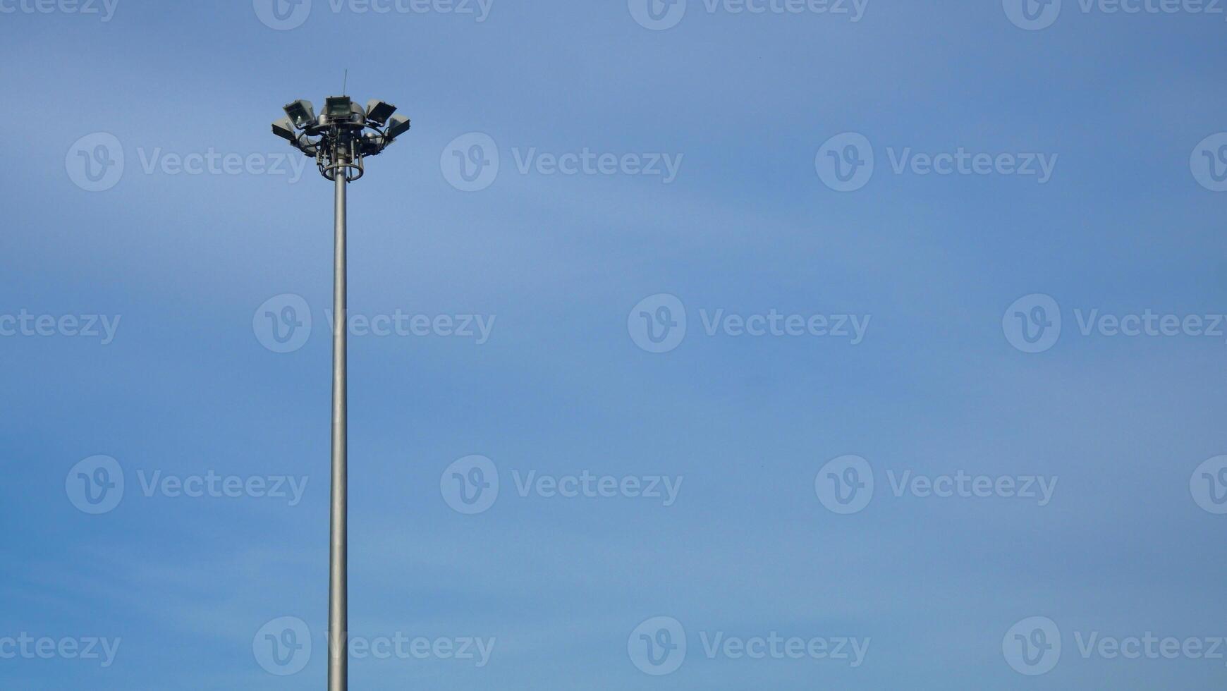 Spotlight pole on the side of the road The background is a blue sky photo