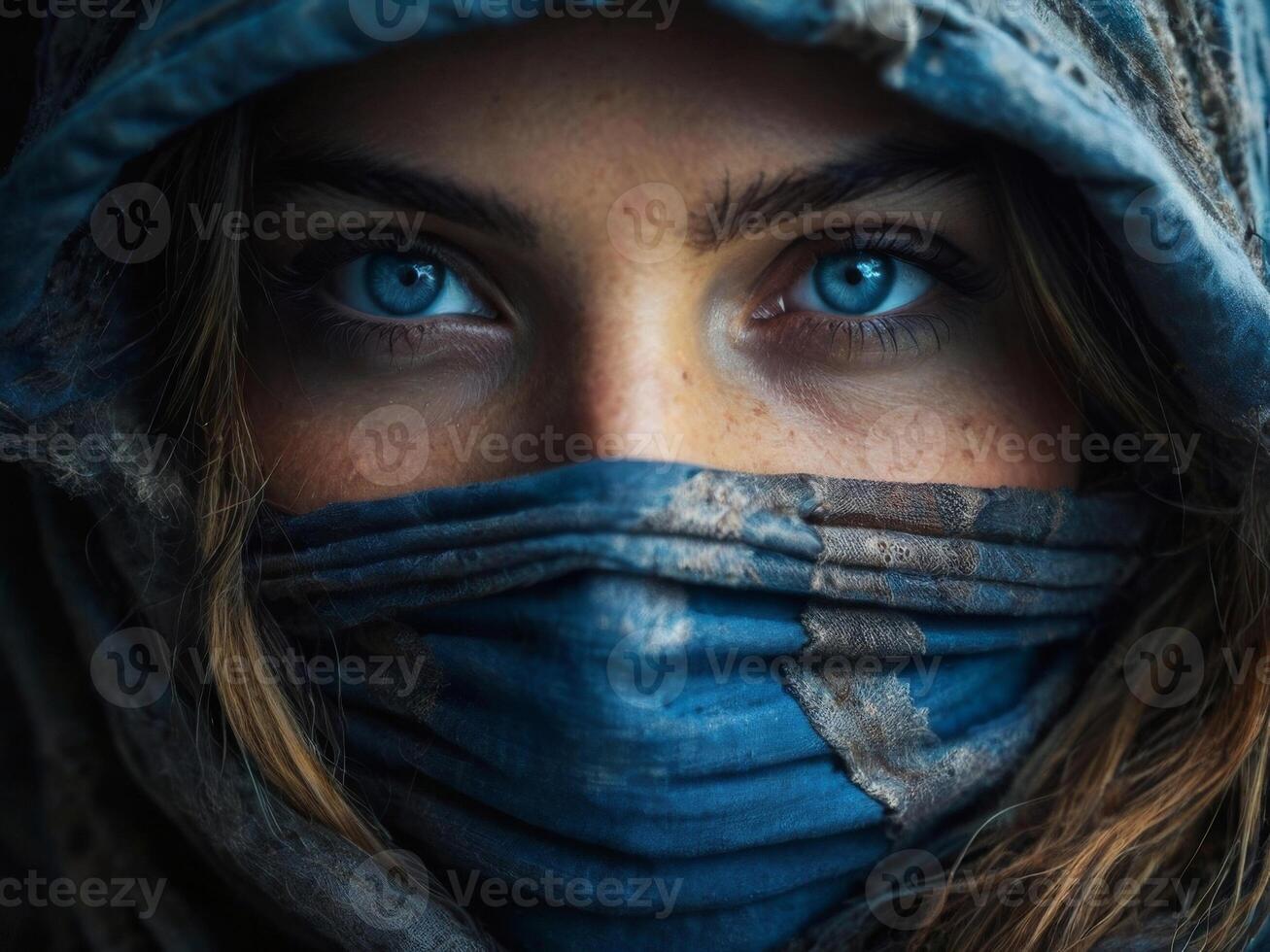 Portrait of a girl with blue eyes in a burqa with her face covered photo