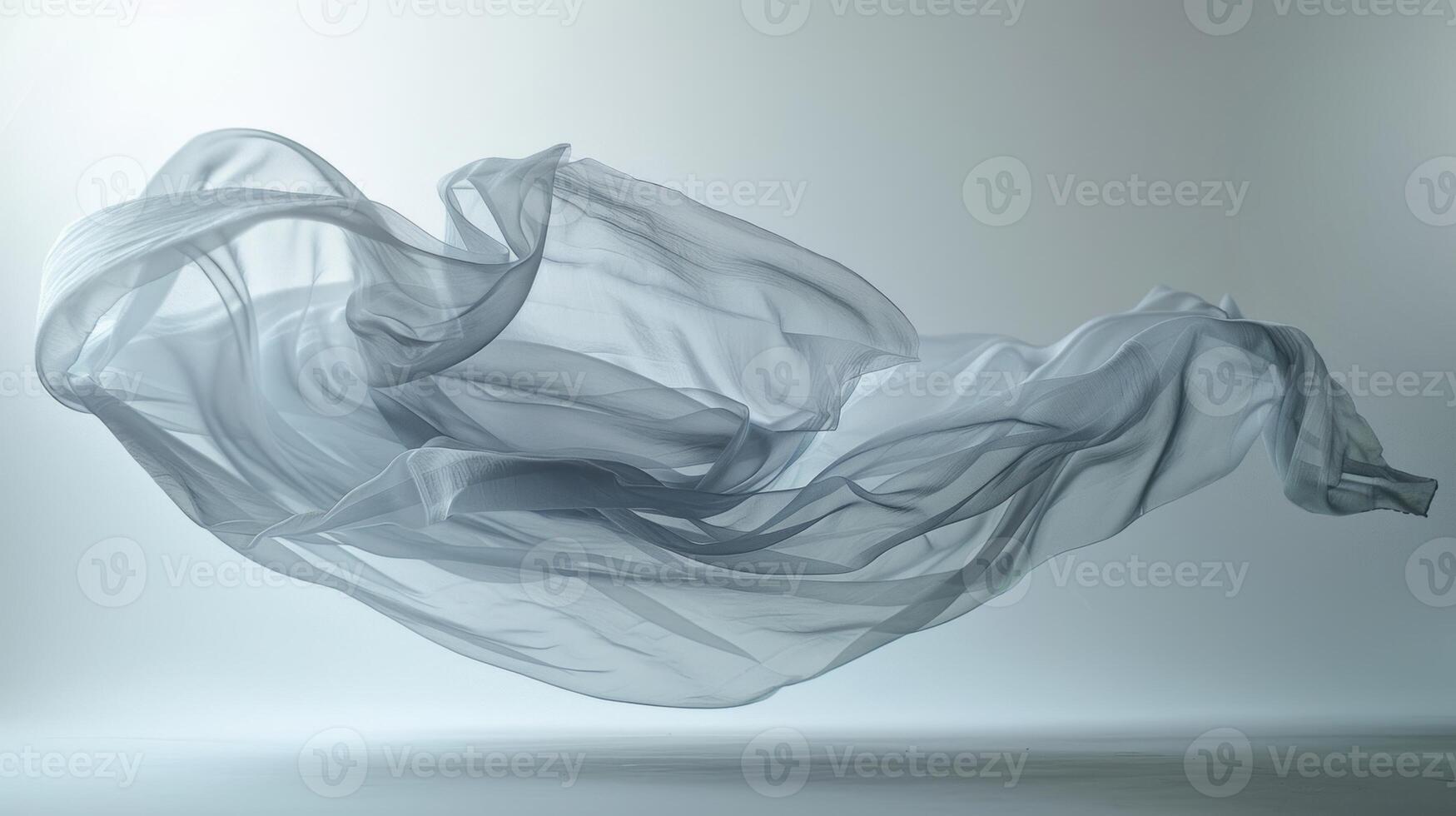 A magical and surreal image captured with a flowing fabric floating in midair suspended by the studio lighting photo