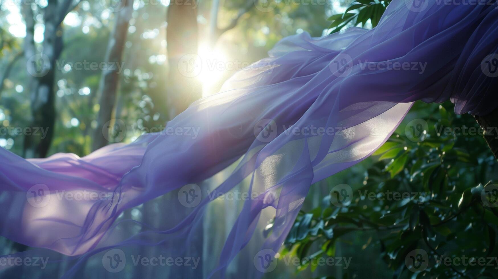 Against the backdrop of towering trees a lavender fabric catches the sunlight and sways gracefully in the gentle breezes of the rainforest photo