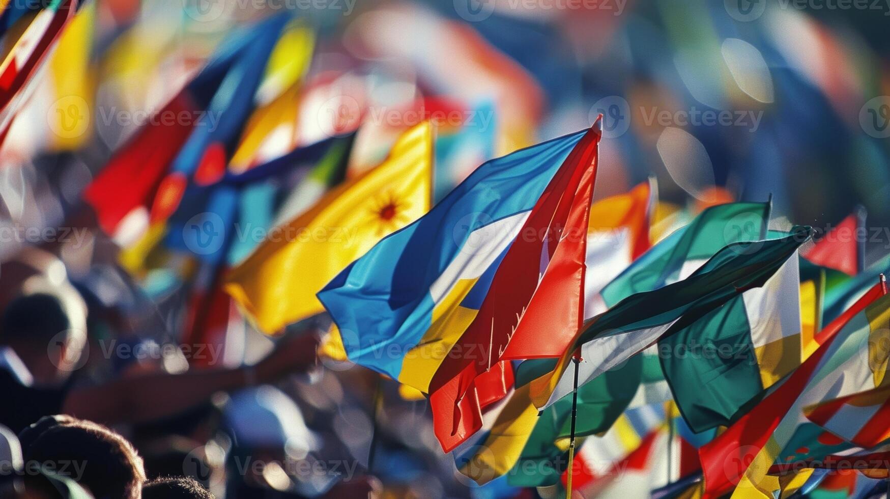 A dynamic scene of flags of various shades and sizes creating a lively and energetic atmosphere at a sporting event photo