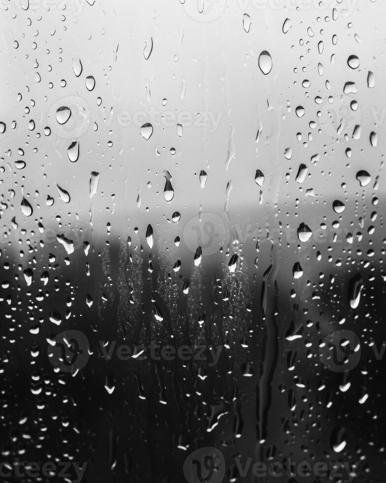 Dramatic patterns formed by the raindrops on the window. Black and white art. photo