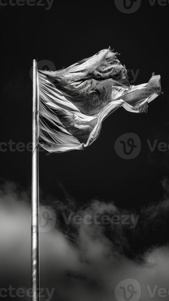 The wind tugs at the fabric of a flag creating a dramatic and dynamic pattern. Black and white art. photo
