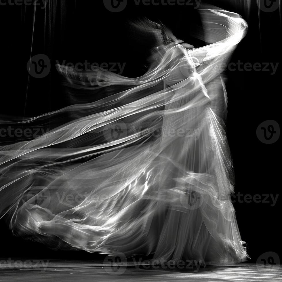 The wind takes hold of a curtain transforming it into a work ofart.t with its graceful movements. Black and white art. photo