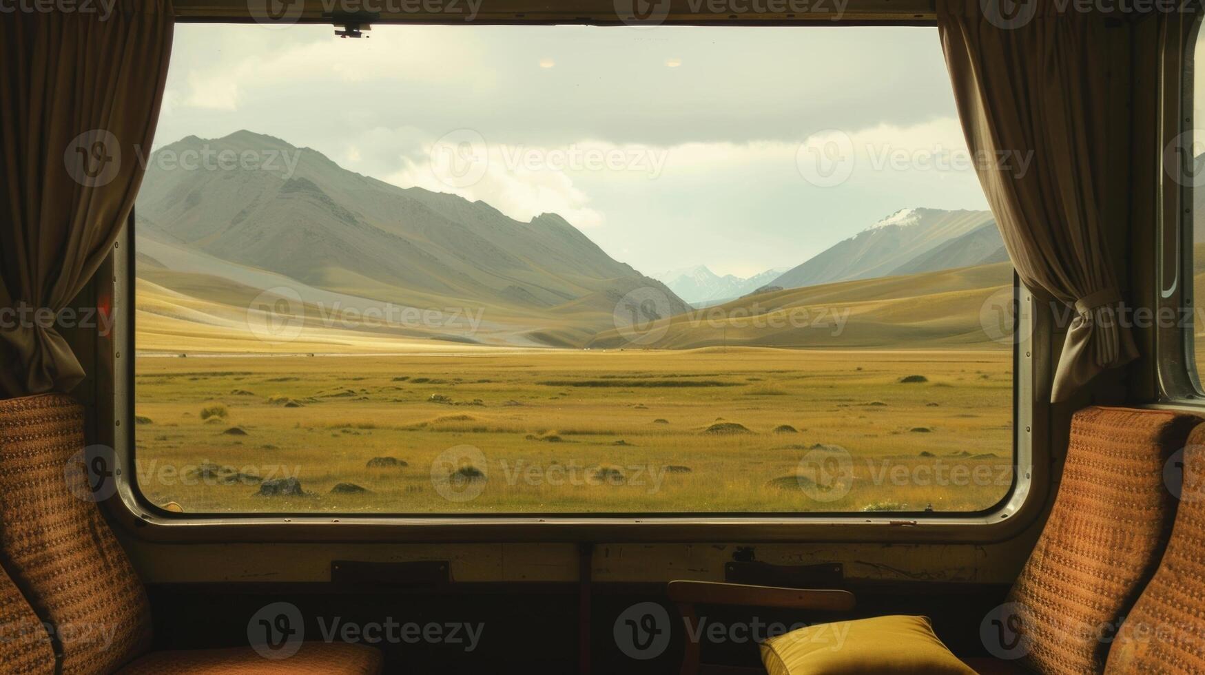 The train is dwarfed by the vastness of the looming mountains all around photo