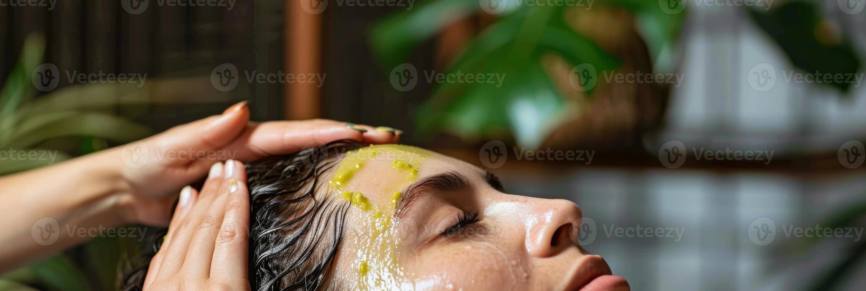 A person with dry itchy scalp massages in avocado oil as a natural remedy for dandruff and scalp irritation photo