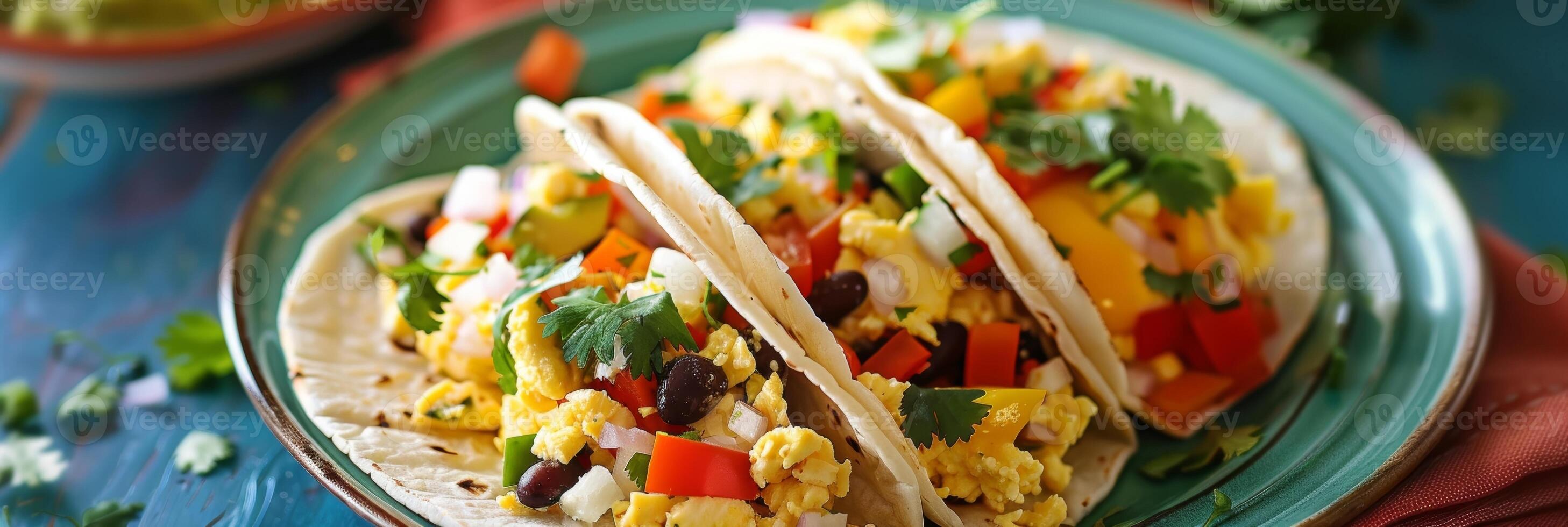 A colorful plate of superfood breakfast tacos made with scrambled eggs bell peppers black beans and a drizzle of avocado oil for a healthy start to the day photo