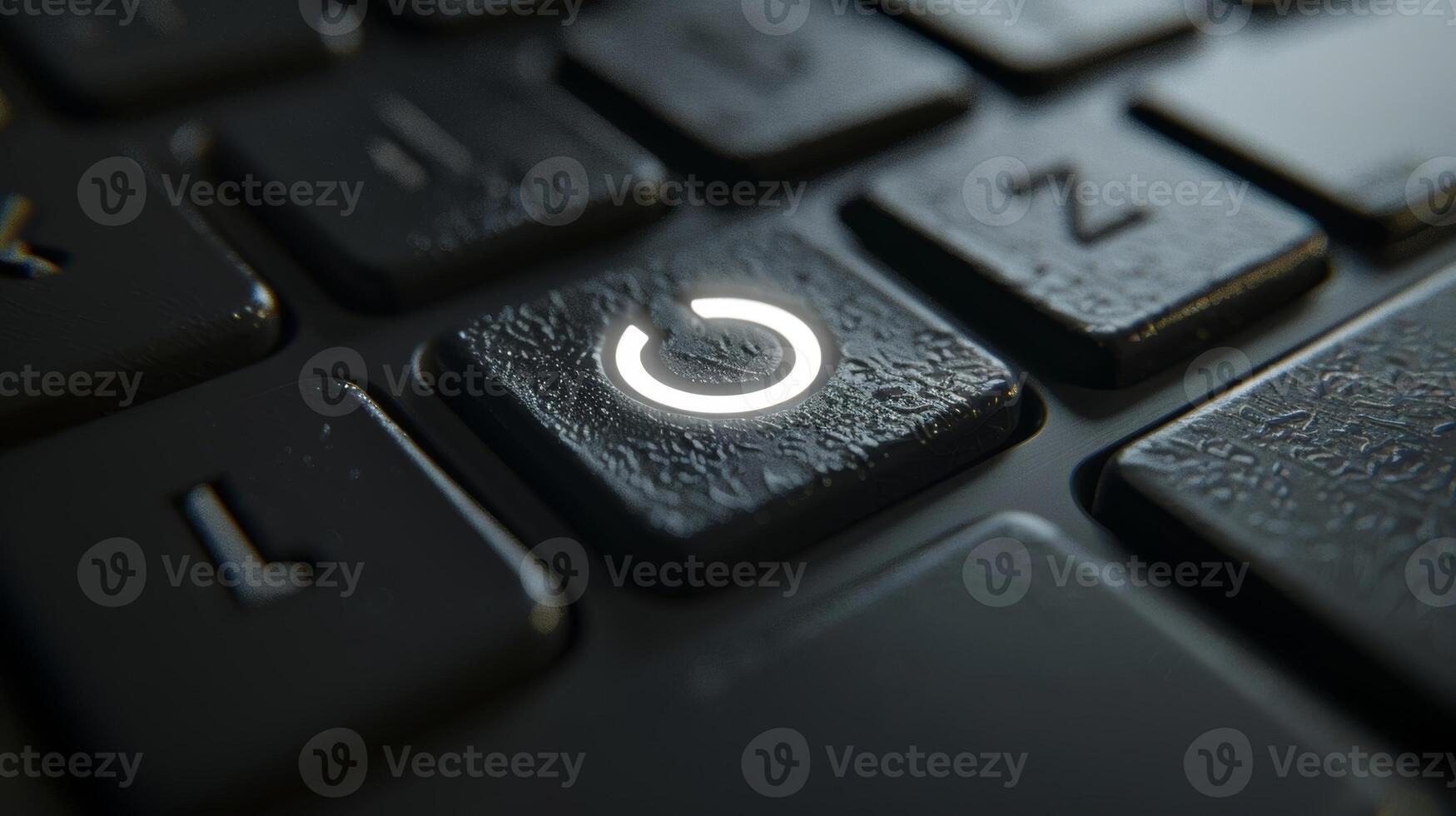 A closeup of a wireless keyboards power button featuring a minimalist design and illuminated by a faint white light photo