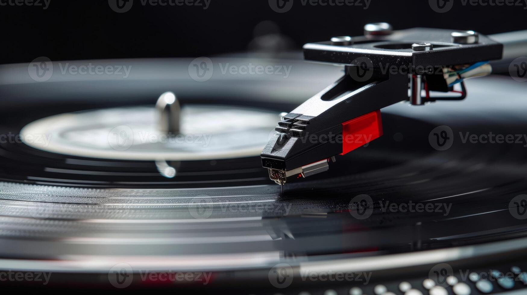 The needle of a turntable delicately grazes the grooves of a vinyl record producing crisp clear soundwaves photo