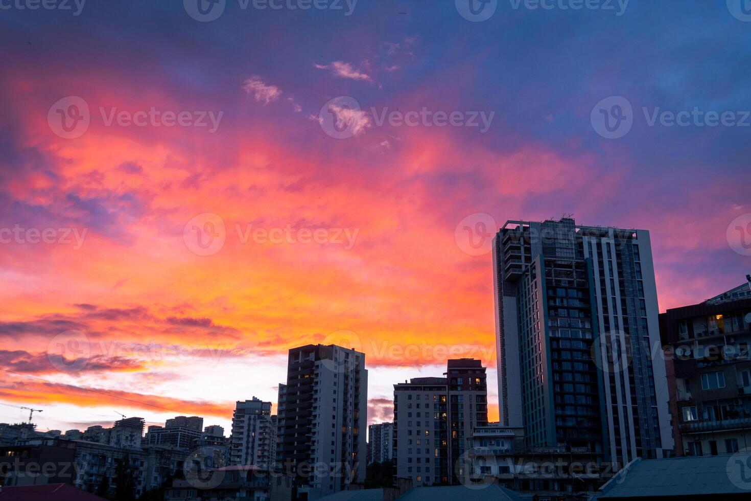 Aerial sky view real estate building facades in Tbilisi, Georgia capital on sunset. Property big city development and high rise buildings. Beautiful Tbilisi sunset banner concept. photo