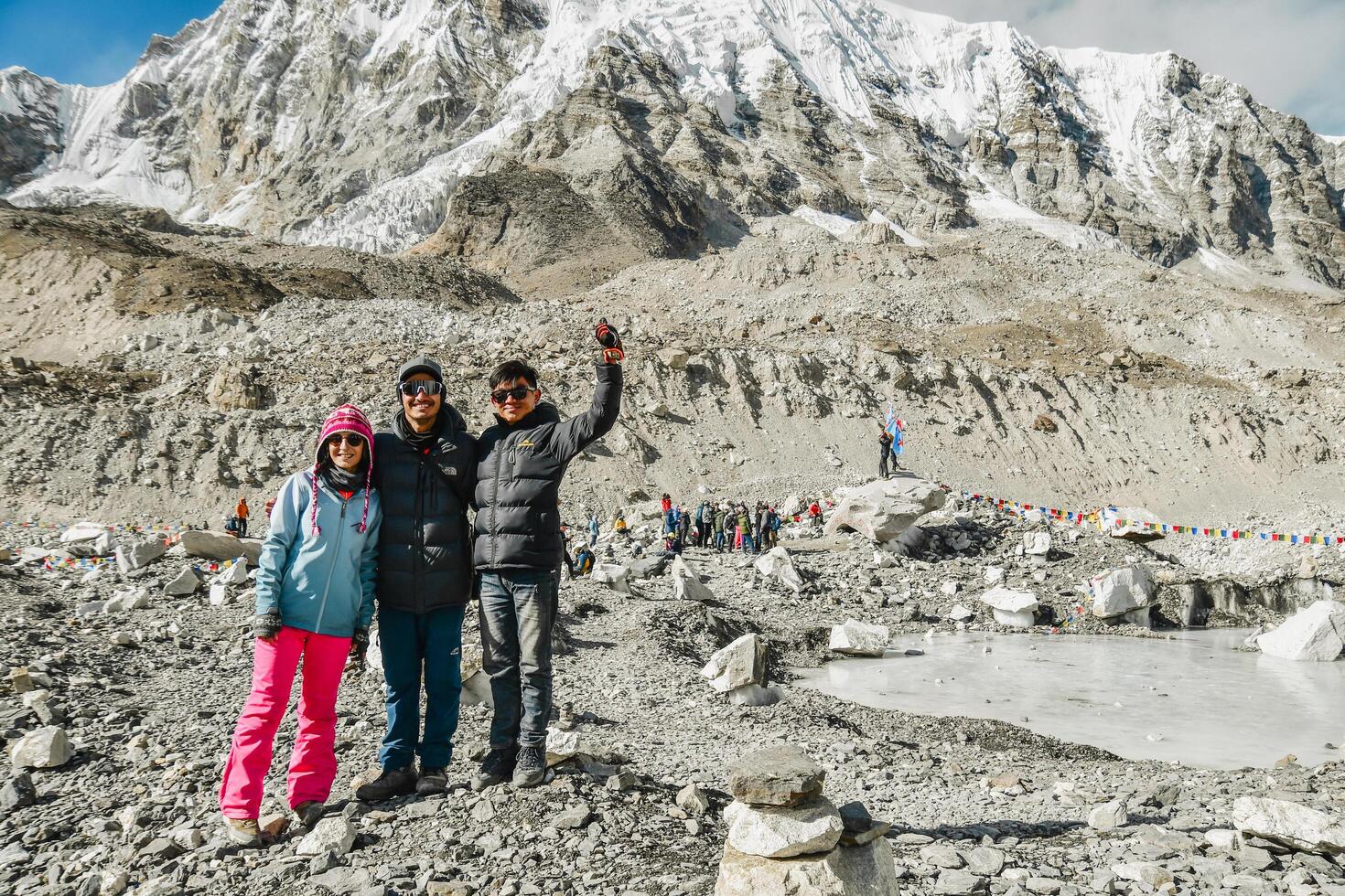 EBC, Nepal - 18th november, 2023 - Nepalese guide and porter, tourist woman on Everest base camp pose looking at camera Himalayas trekking EBC. Nepalese Sherpas and tourist client photo