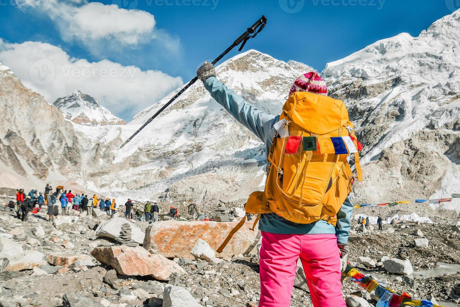 Close up back view caucasian woman stand joyful made it to top solo to Everest base camp viewpoint.. Majestic Himalayas mountains.Challenge achievement concept.Sunny trekking EBC photo