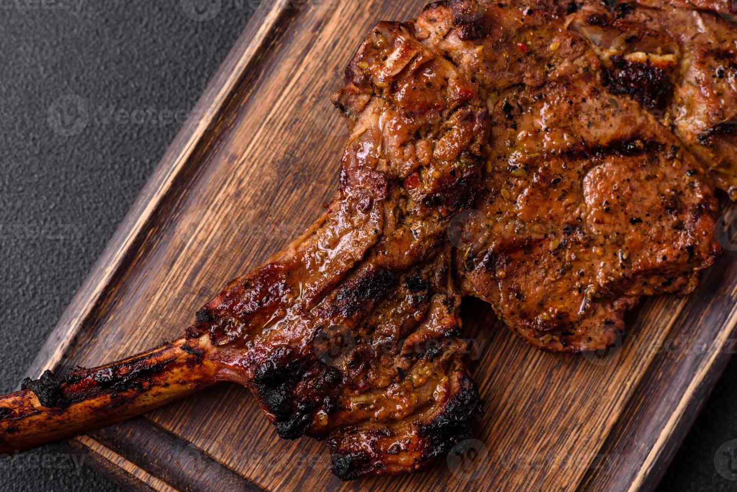 Juicy beef tomahawk steak on the bone baked on the grill photo