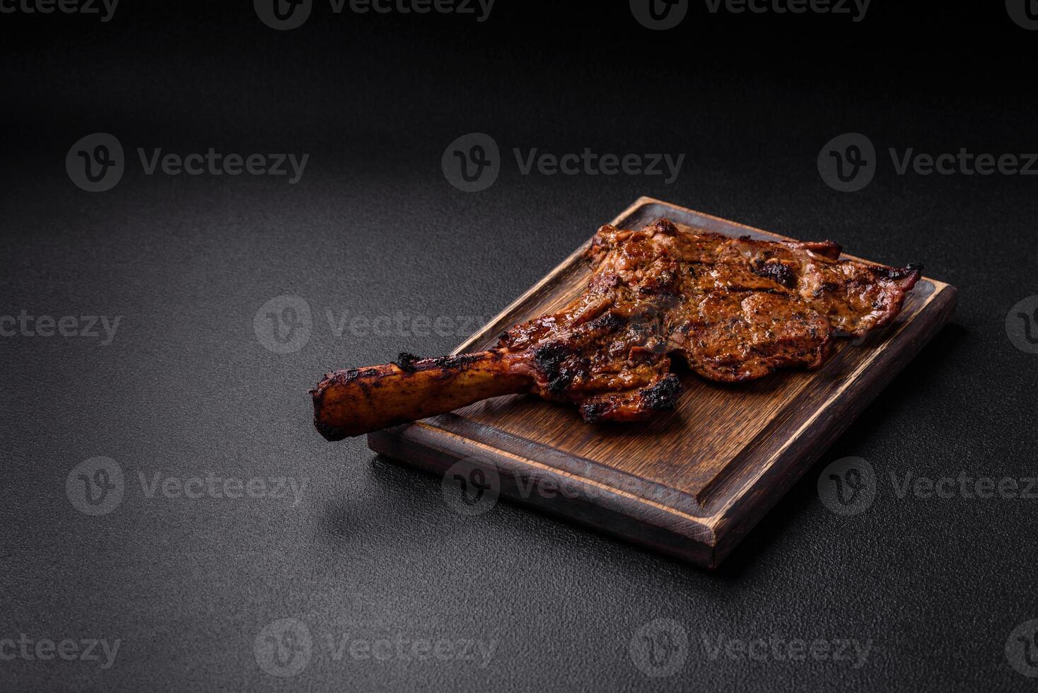 Juicy beef tomahawk steak on the bone baked on the grill photo