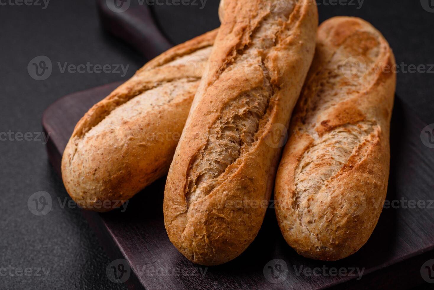 Crispy mini baguette with seeds and grains, salt and spices photo