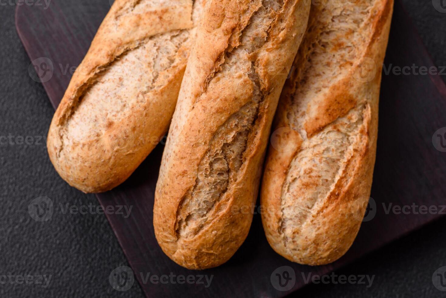 Crispy mini baguette with seeds and grains, salt and spices photo
