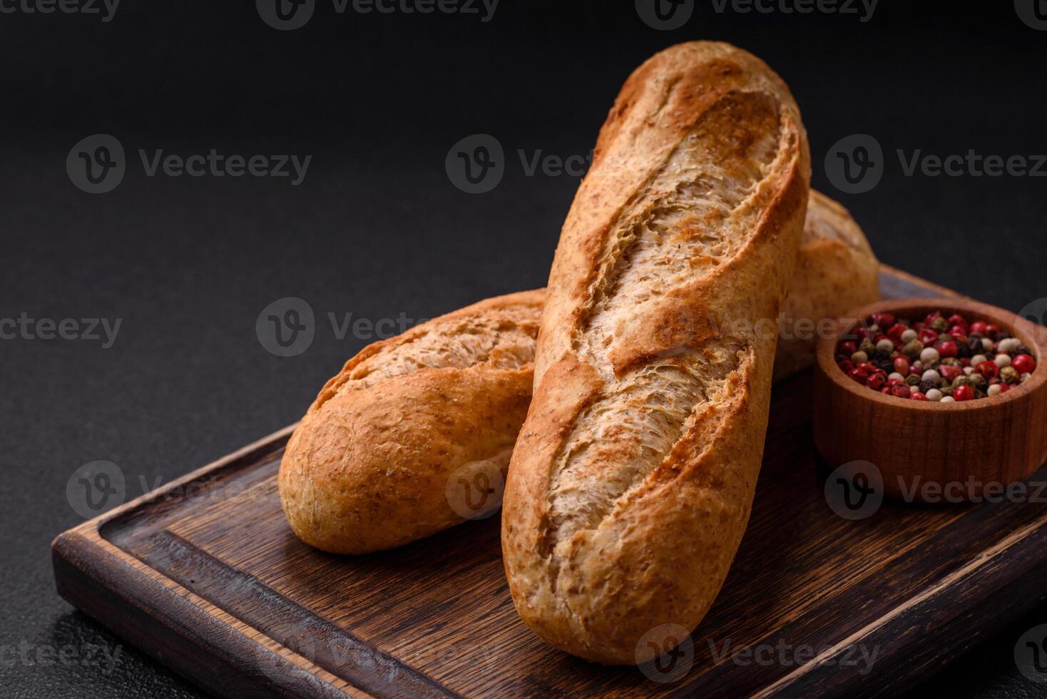 Crispy mini baguette with seeds and grains, salt and spices photo