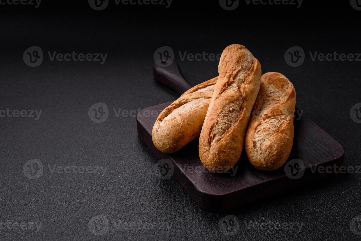 Crispy mini baguette with seeds and grains, salt and spices photo