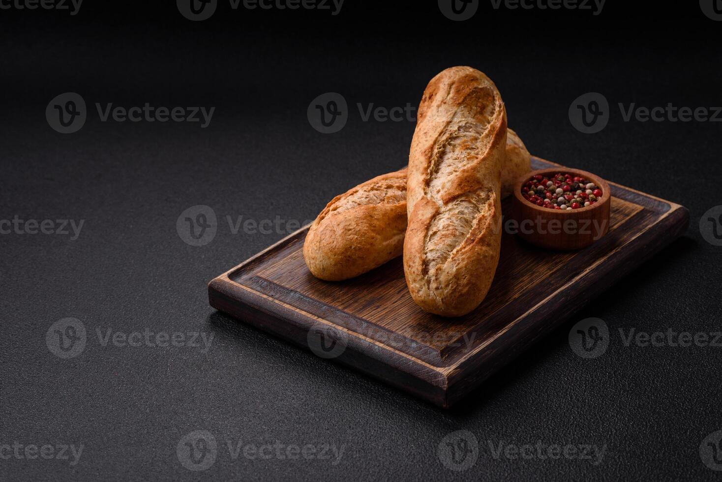 Crispy mini baguette with seeds and grains, salt and spices photo