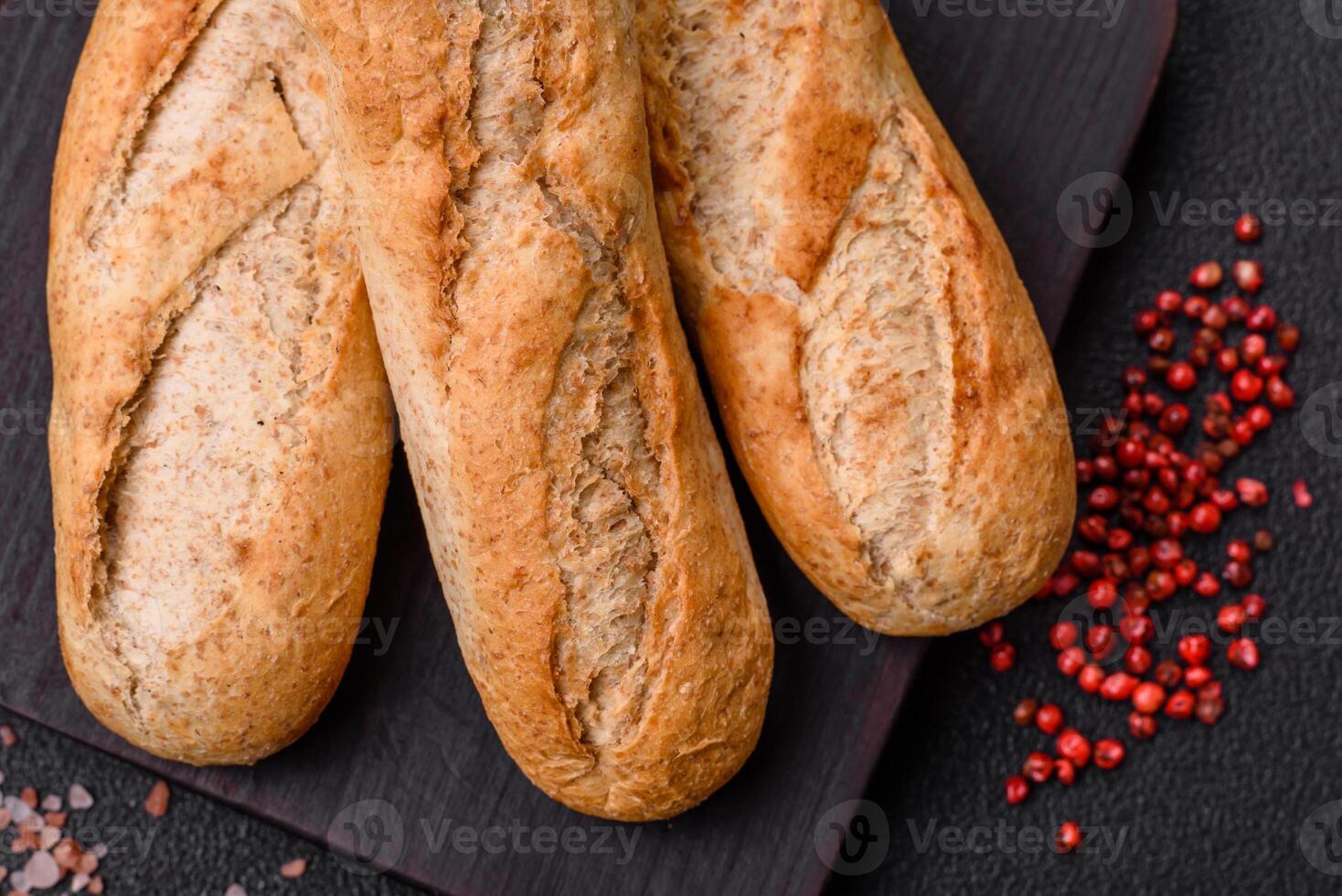 Crispy mini baguette with seeds and grains, salt and spices photo