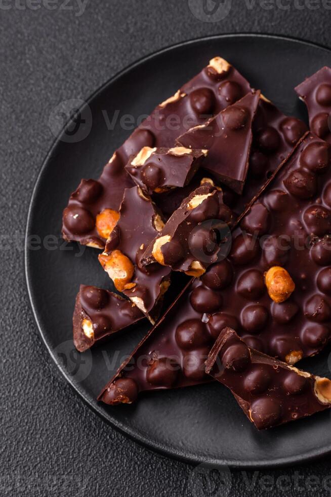 Black bitter chocolate with whole hazelnuts, candied fruits and mint photo