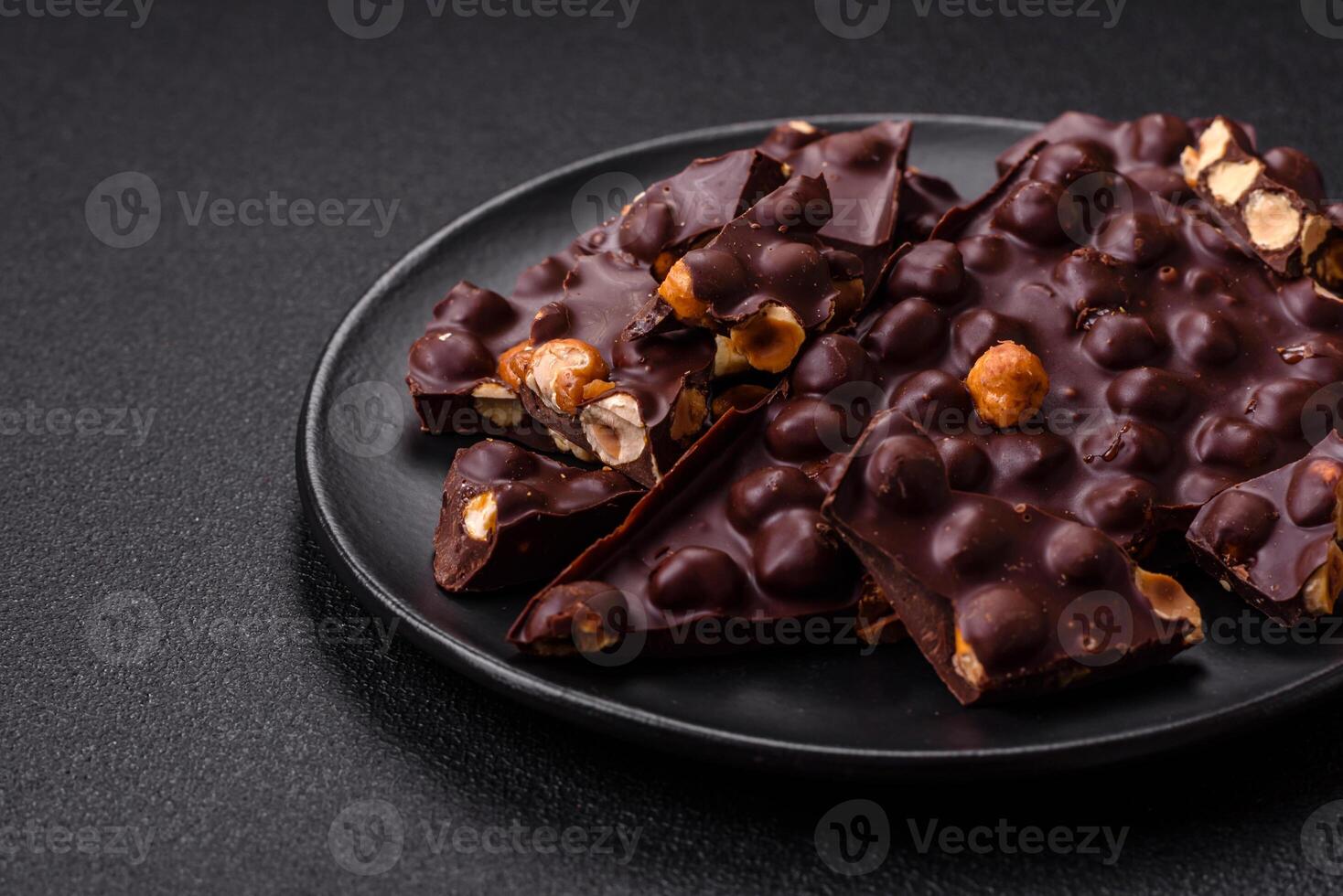 Black bitter chocolate with whole hazelnuts, candied fruits and mint photo