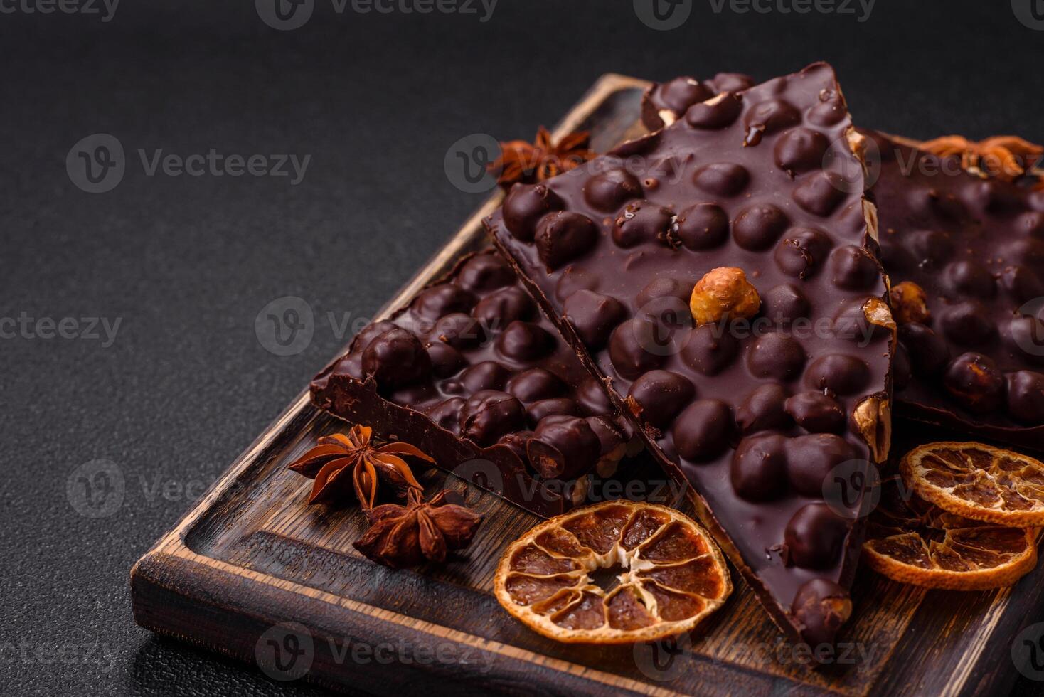 Black bitter chocolate with whole hazelnuts, candied fruits and mint photo
