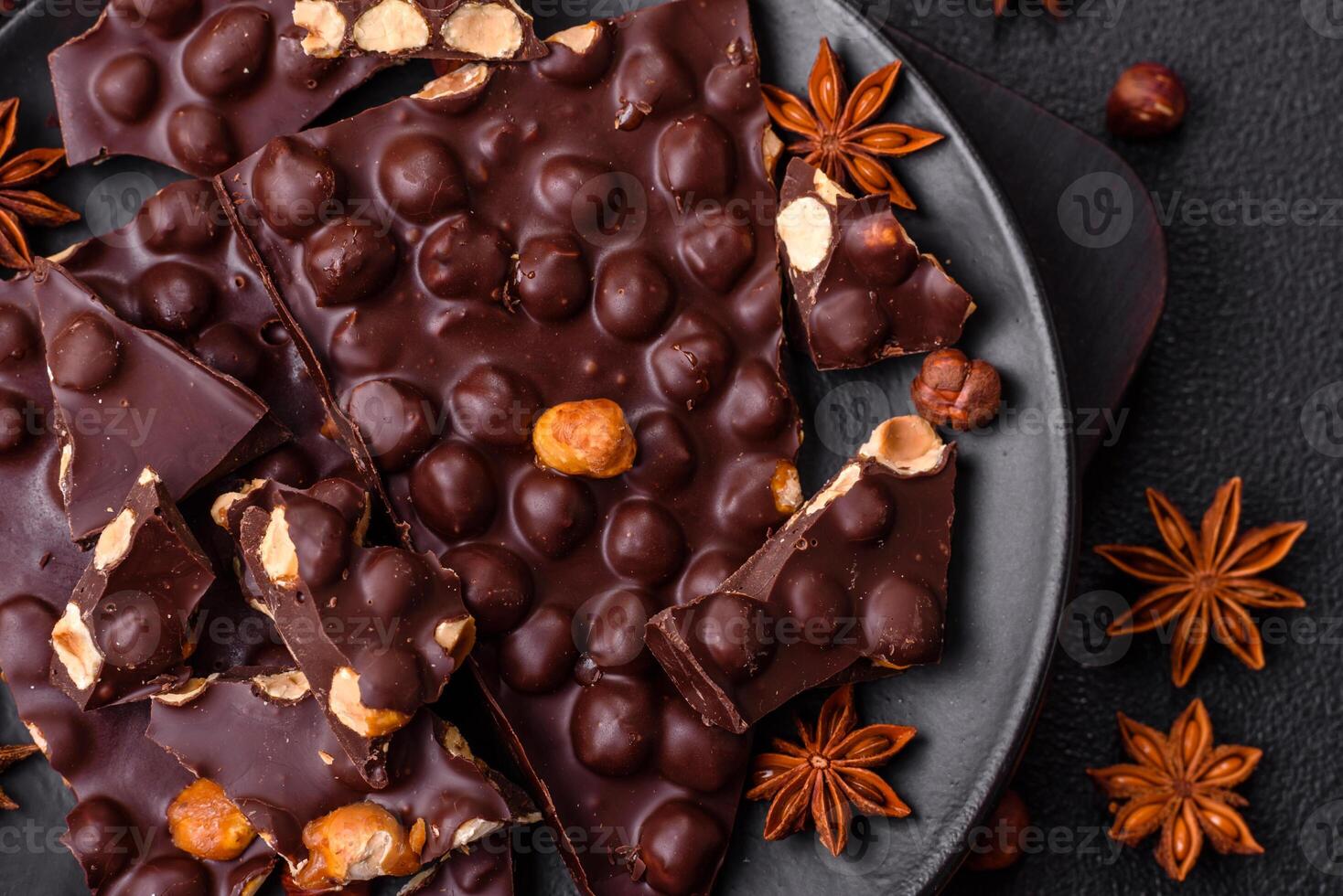 Black bitter chocolate with whole hazelnuts, candied fruits and mint photo