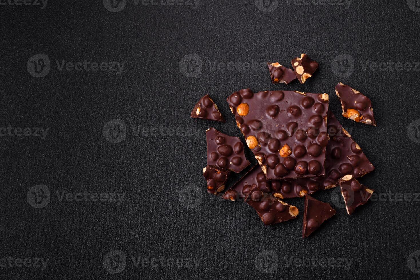 Black bitter chocolate with whole hazelnuts, candied fruits and mint photo