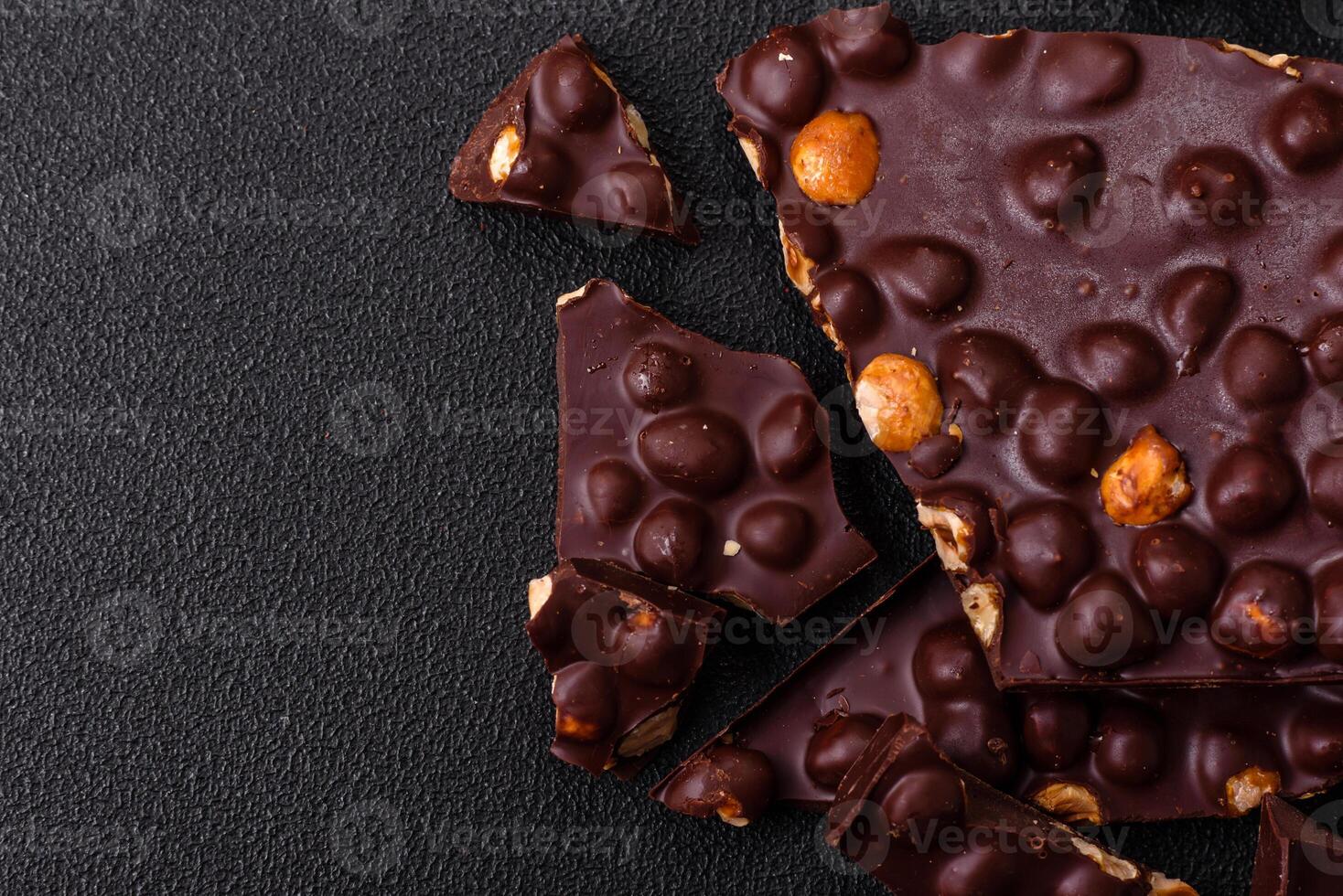 Black bitter chocolate with whole hazelnuts, candied fruits and mint photo