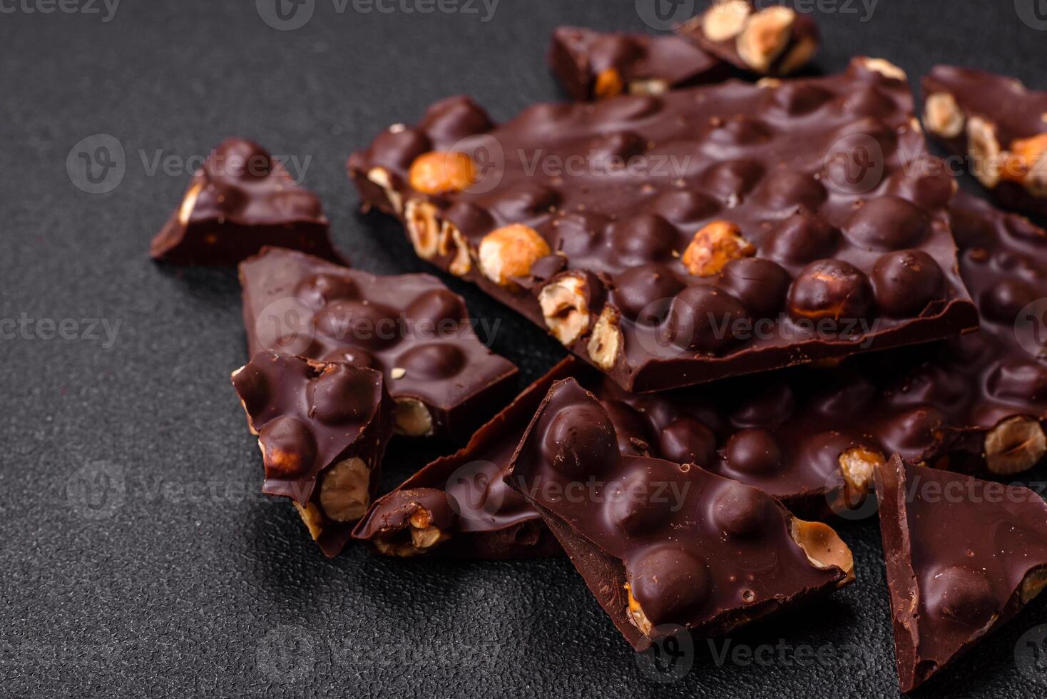 Black bitter chocolate with whole hazelnuts, candied fruits and mint photo