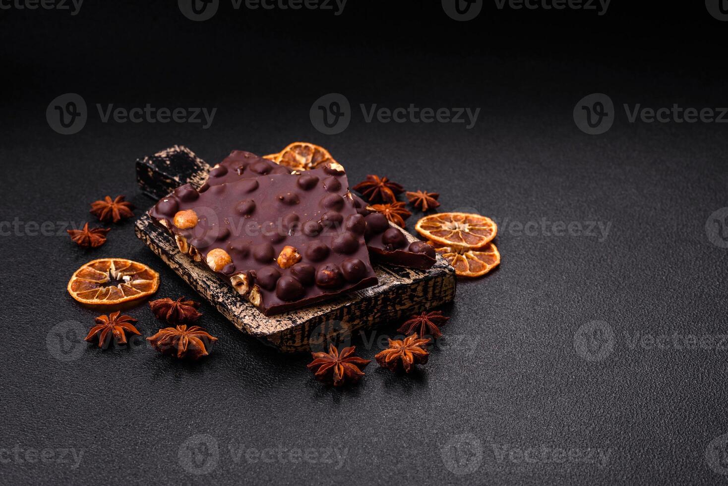 Black bitter chocolate with whole hazelnuts, candied fruits and mint photo