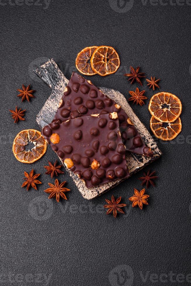 Black bitter chocolate with whole hazelnuts, candied fruits and mint photo