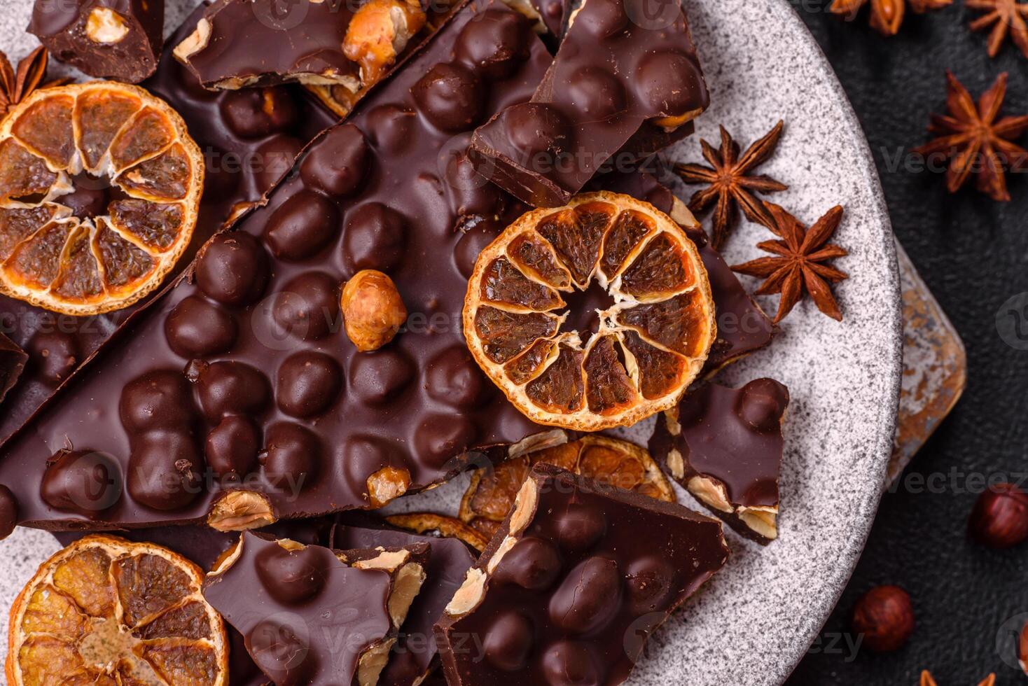 Black bitter chocolate with whole hazelnuts, candied fruits and mint photo