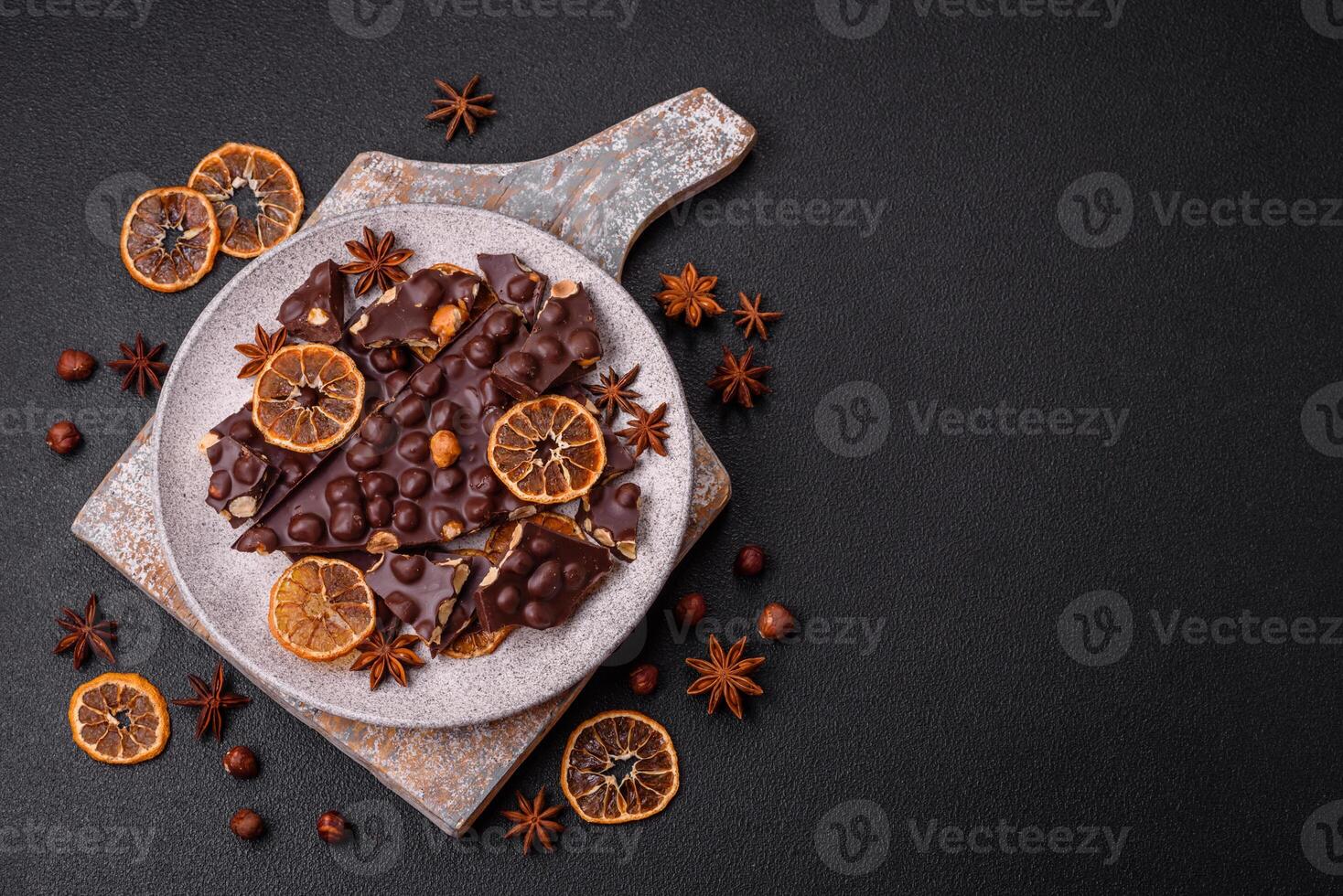 Black bitter chocolate with whole hazelnuts, candied fruits and mint photo