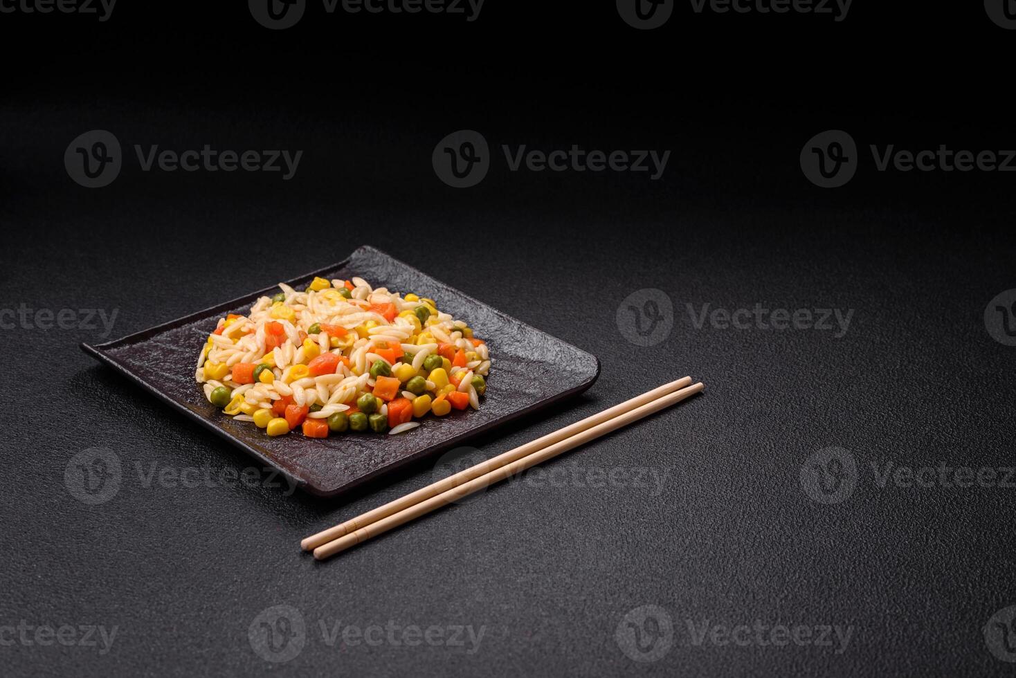 Delicious boiled rice with vegetables corn, carrots, peas with salt photo
